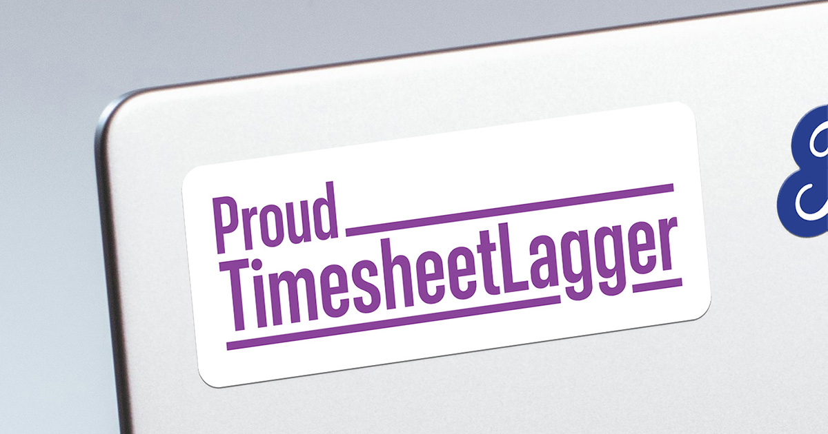 A white rectangular sticker on a silver laptop lid, reading "Proud TimesheetLagger" in purple condensed type with underlines running through the words.